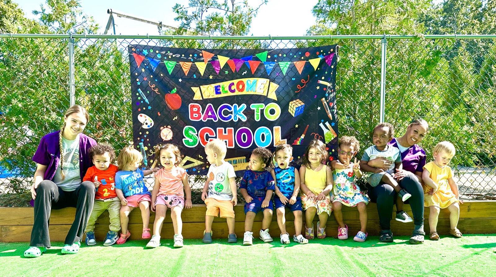 Pine Tree staff and children gathered together outside for a Welcome Back to School celebration