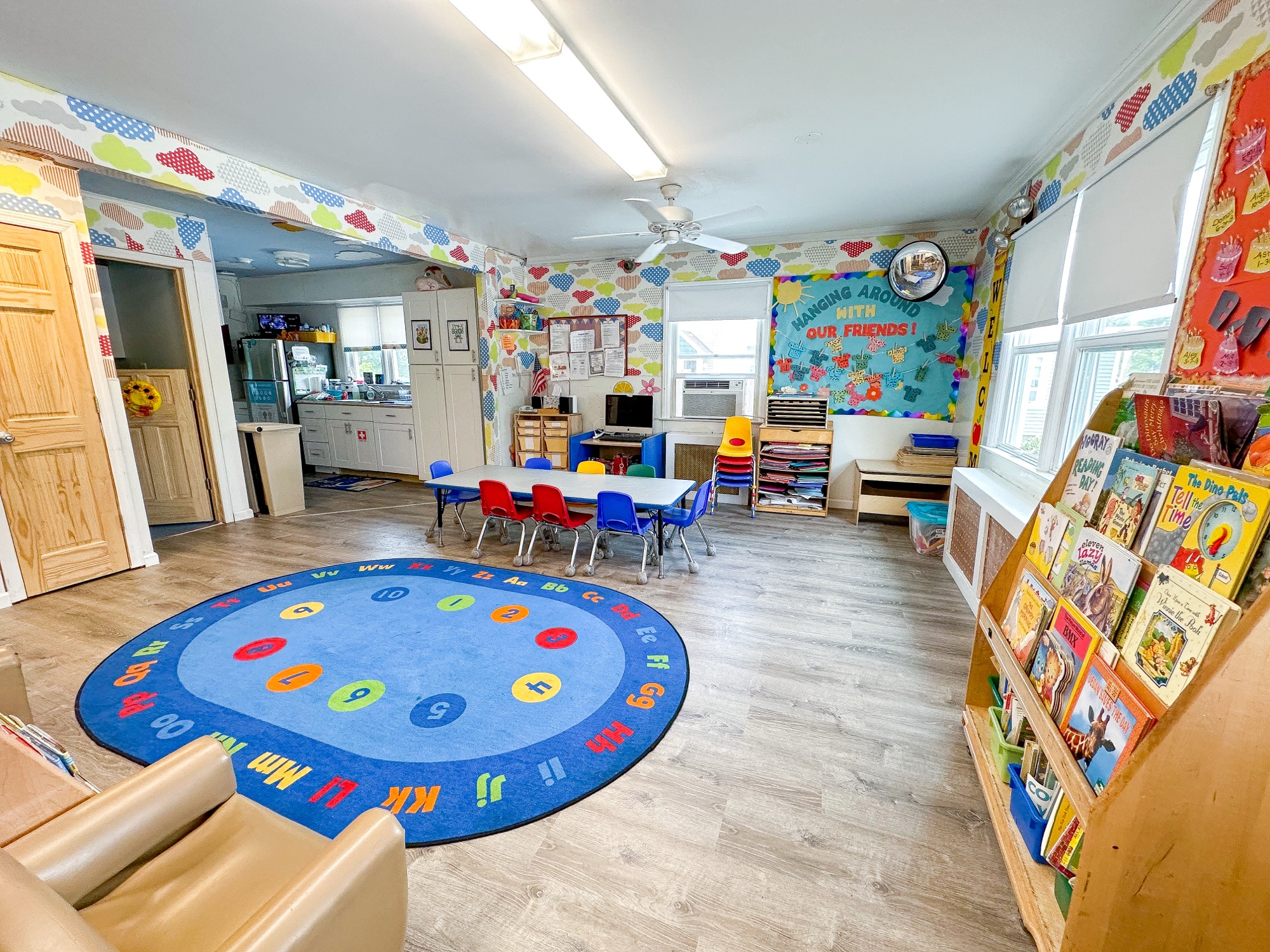 A Pine Tree classroom filled with books, learning rugs, and activity centers