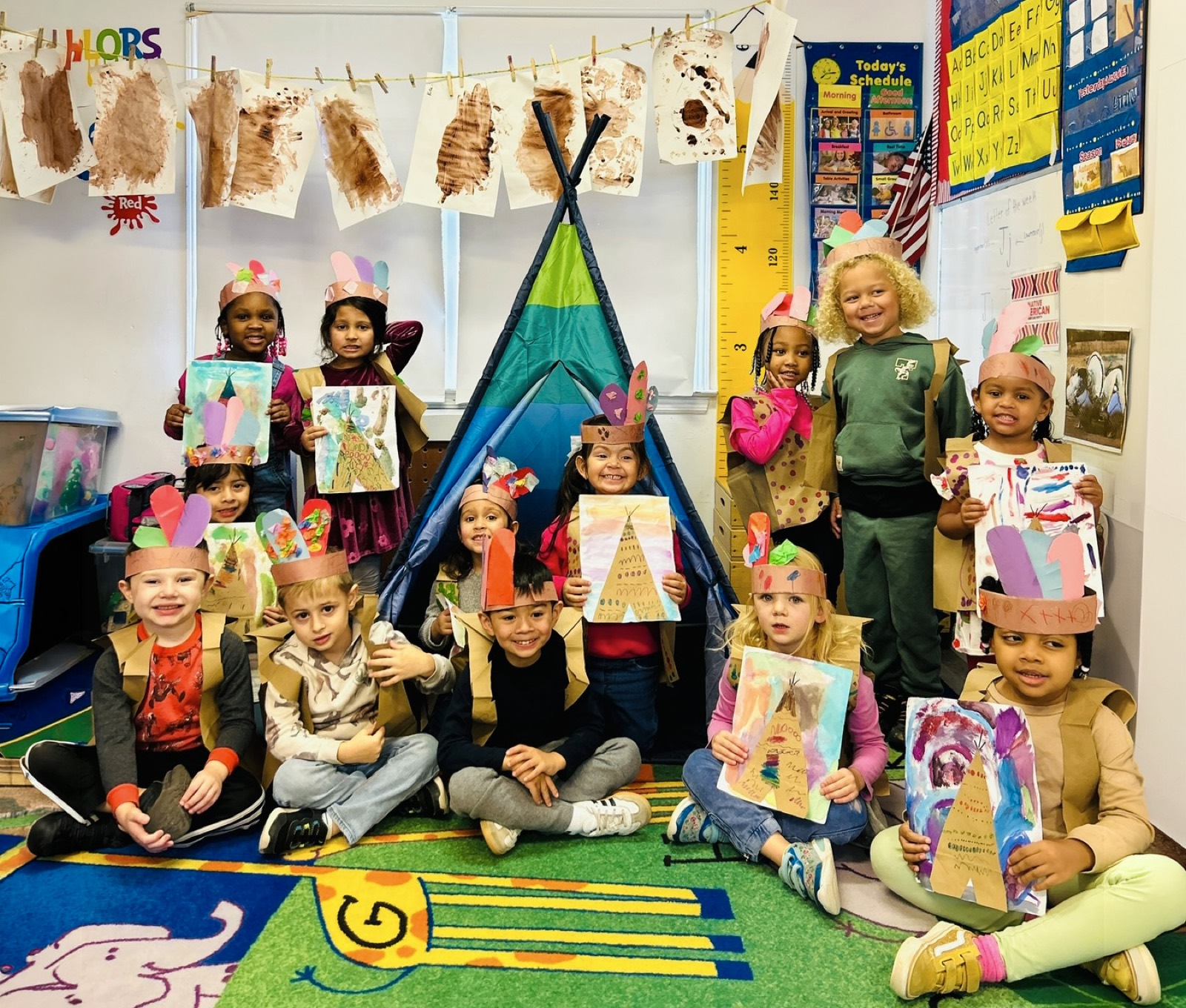 Preschoolers showing off their teepee craft projects