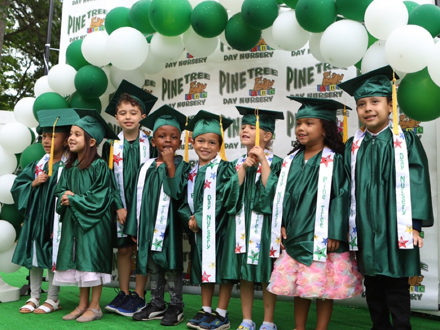 Pre-K graduates in caps and gowns celebrating