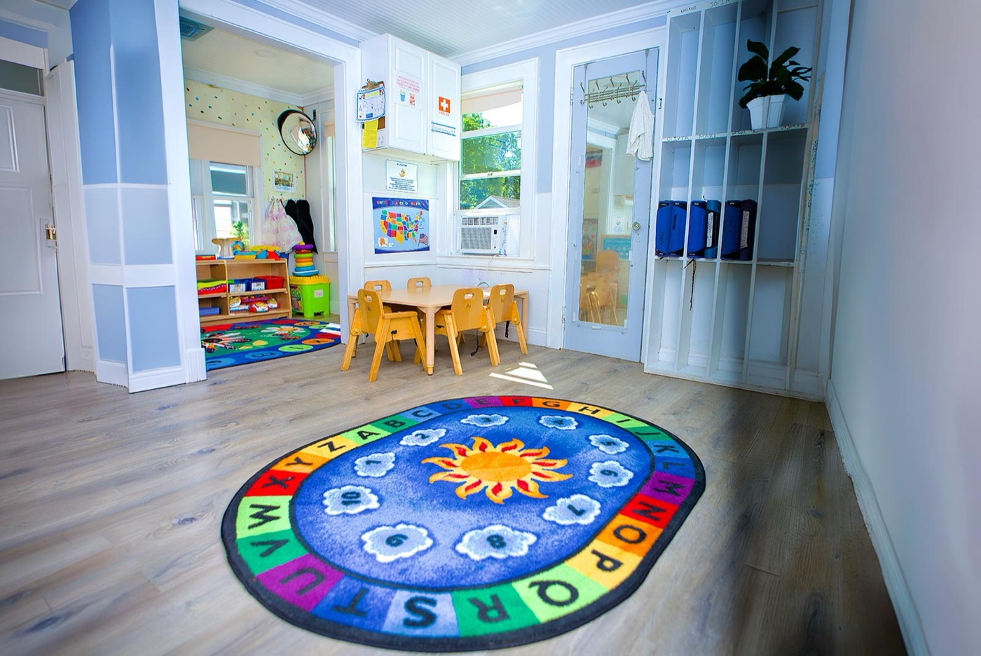 A Pine Tree nursery room with an alphabet rug and child-sized table
